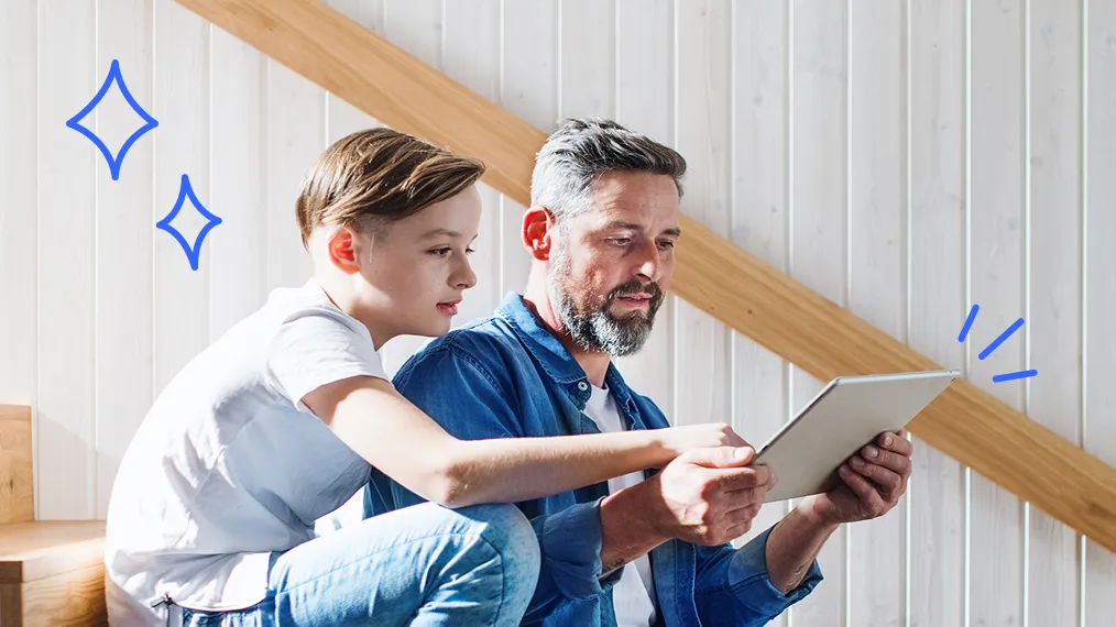 Father and son looking at tablet.